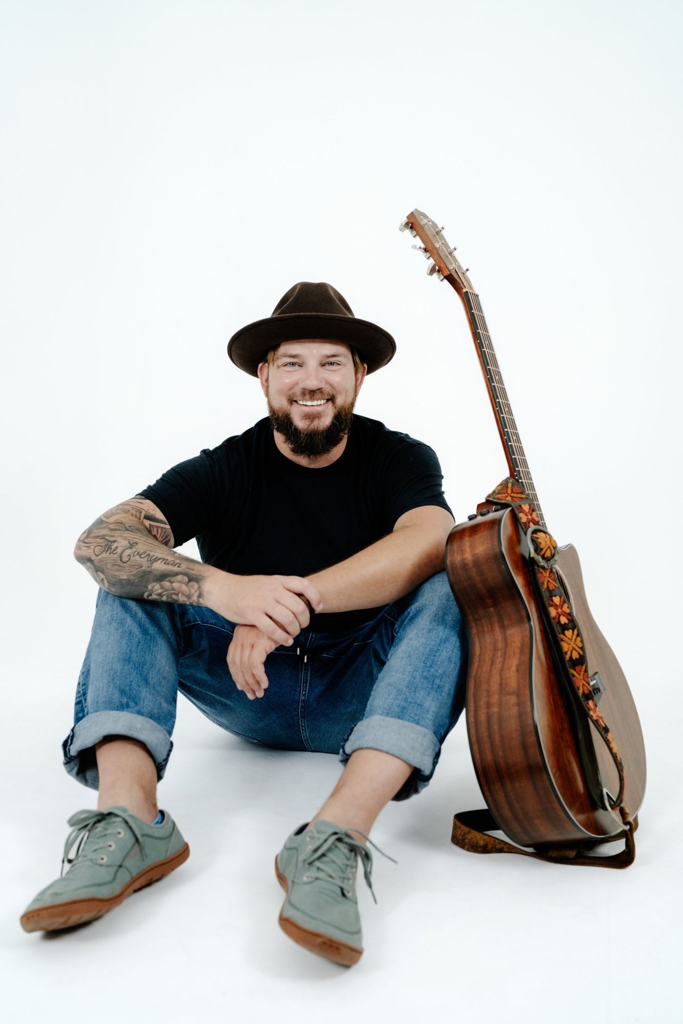Colin Roberts sitting with his guitar